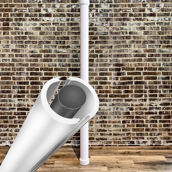 Lally column cover against a rustic brick wall, showcasing its sleek design and protective feature, ideal for enhancing interior aesthetics while maintaining structural support.