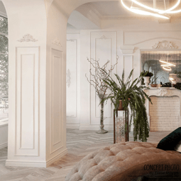 Elegant interior showcasing detailed panel moulding corners, complemented by a cozy plush sofa, modern lighting, and lush greenery, creating a sophisticated living space ambiance.