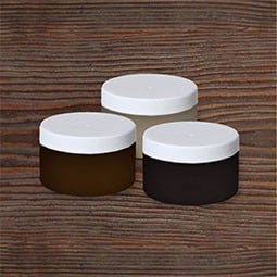 Stylish display of three round jars on rustic wooden surface, highlighting versatility in color samples and touch-up kits for various applications. Ideal for DIY enthusiasts and professionals.