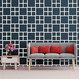 Stylish living room featuring a modern fretwork wall panel design, complemented by a gray sofa and vibrant red cushions, enhancing the contemporary aesthetic.