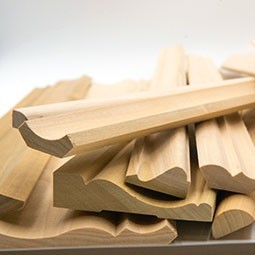 Showcase of various wood moulding and trim pieces, highlighting their unique textures and profiles, perfect for enhancing interior design and craftsmanship projects.